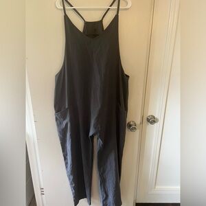 Navy blue romper with pockets and small zipper detail on back.